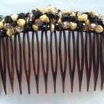 golden and black color wire wrapped comb
