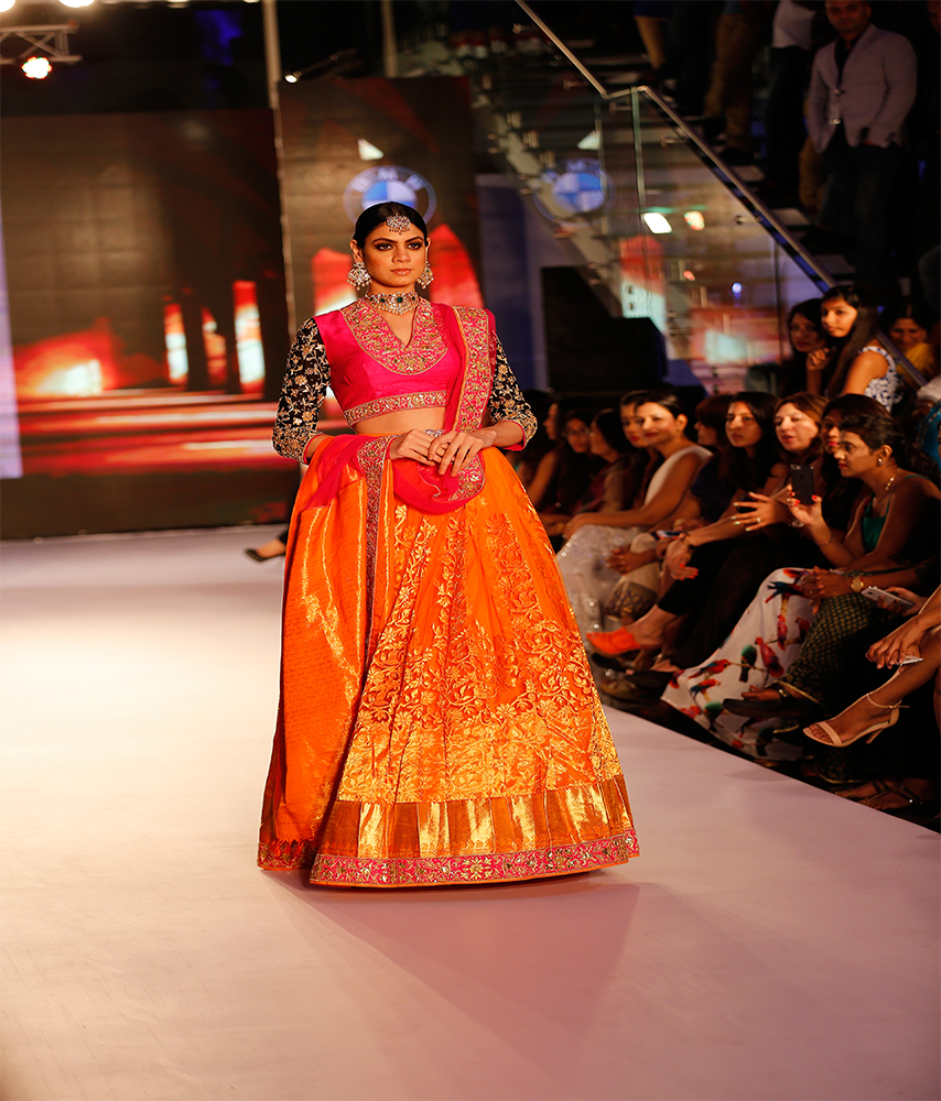 orange net lehenga with rani pink blouse and embellished sleeve bridal collection